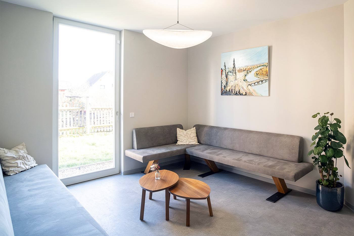 Wartezimmer der Zahnarztpraxis & Oralchirurgie ELBIMPLANT mit gemütlicher Couch, Tisch, Pflanzen